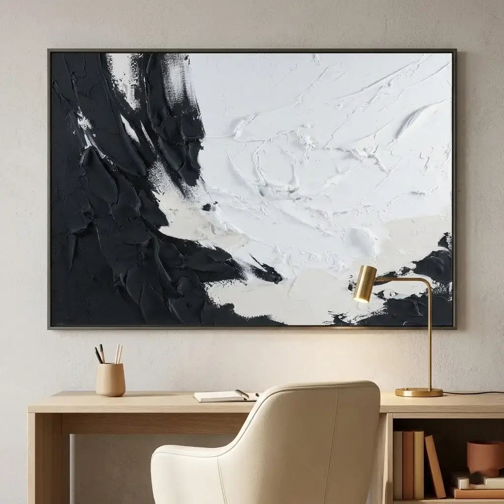 Dining room with a round table and chairs, abstract black and white painting on the wall.