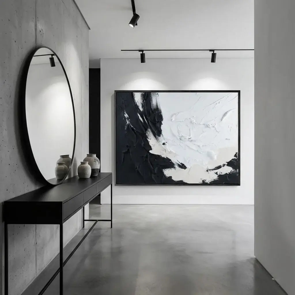 Modern interior with abstract art, round mirror, and console table.