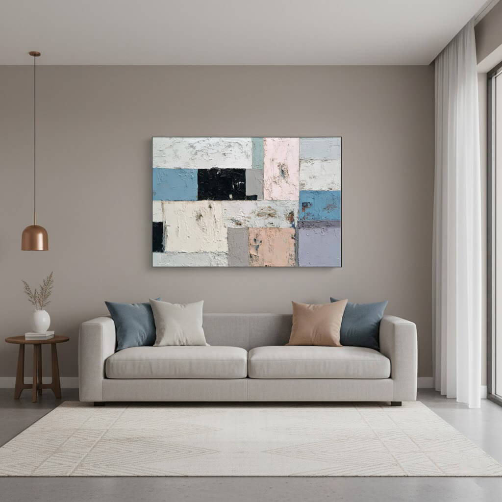 Modern living room with a gray sofa, abstract art, and minimal decor.