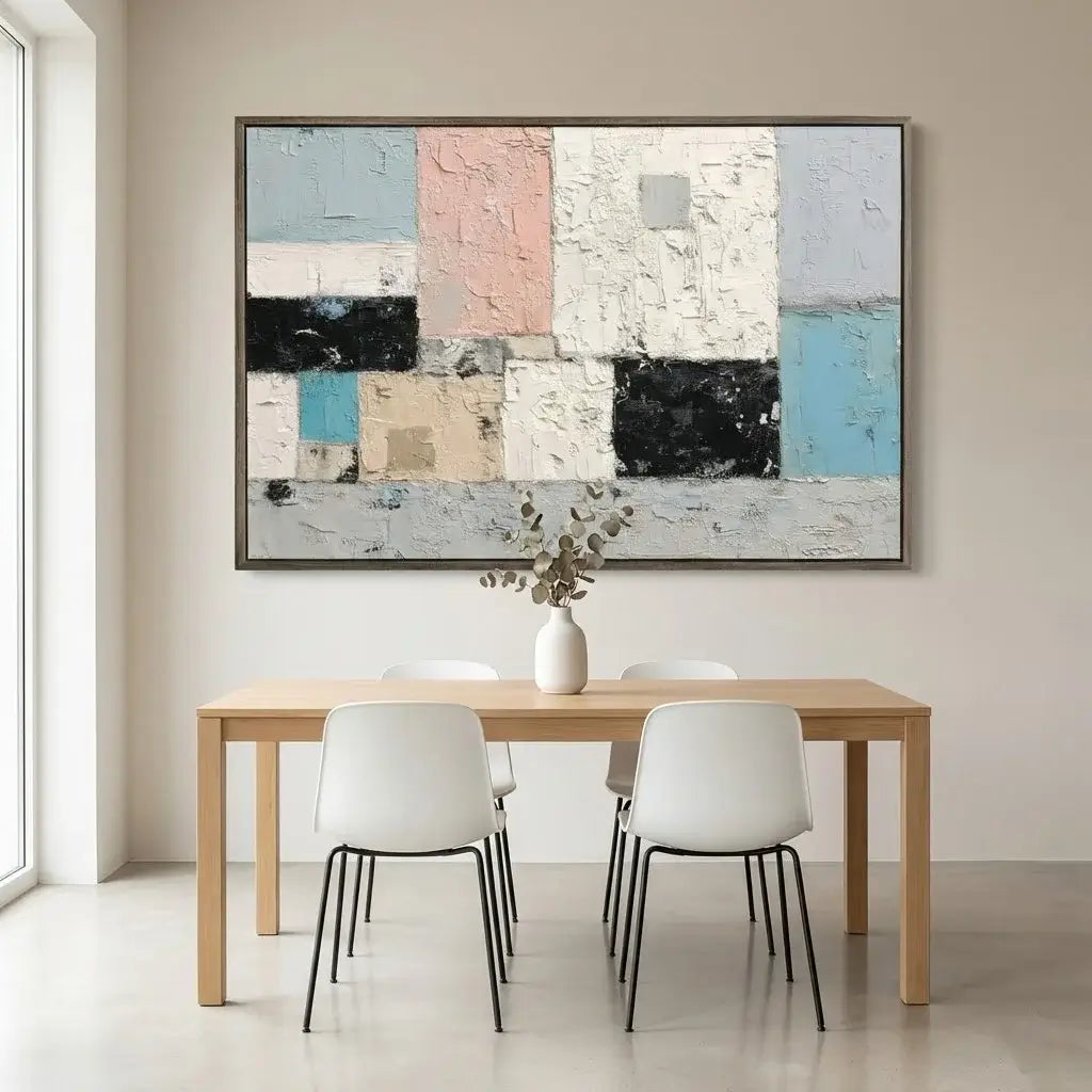Dining room with a wooden table and white chairs, featuring a large abstract painting on the wall.