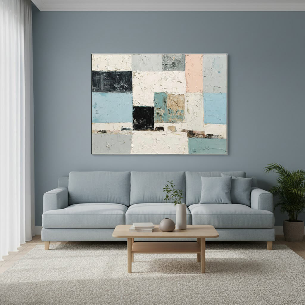 Living room with a gray sofa, wooden coffee table, and abstract art on the wall.