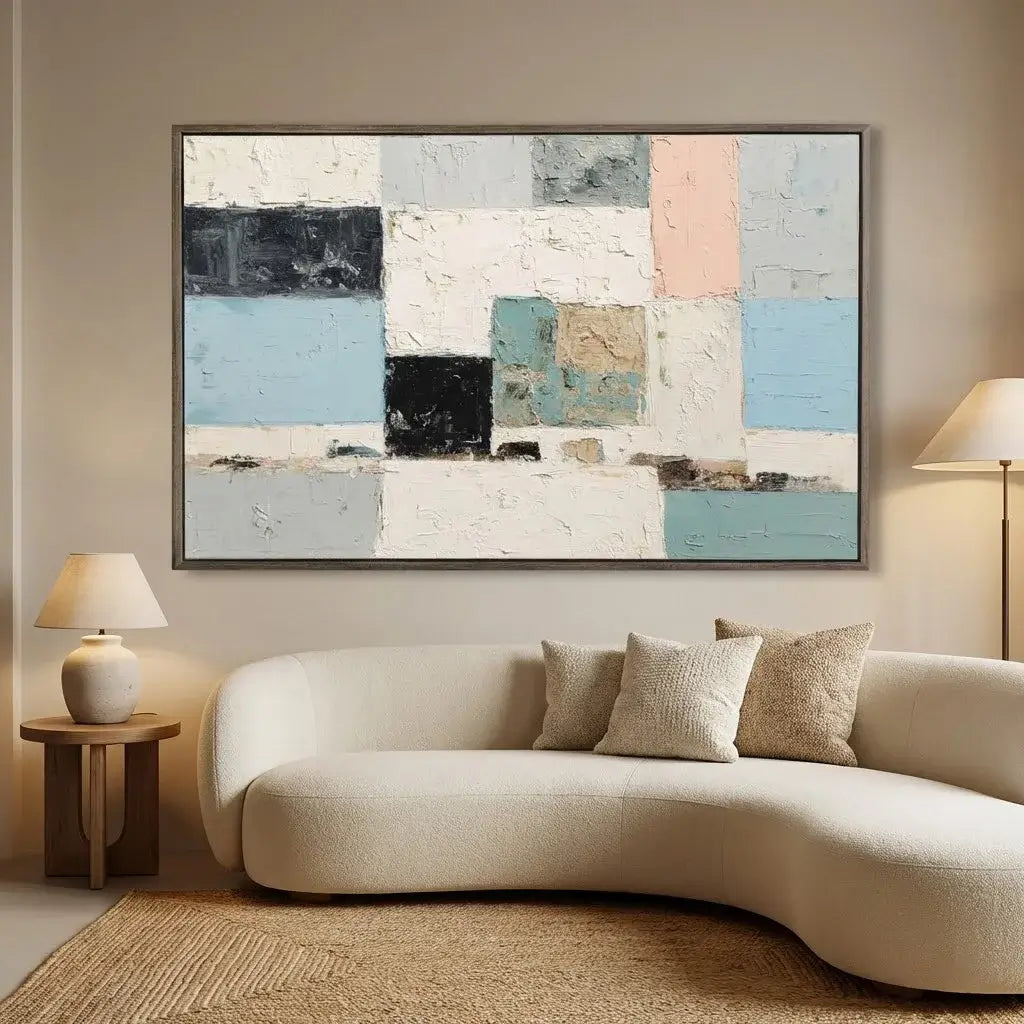 Abstract art piece on a wall above a modern sofa in a living room.