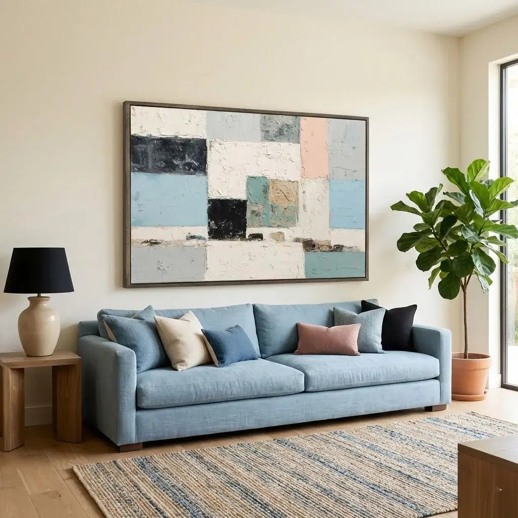 Living room with a blue sofa, abstract painting, and decorative items.