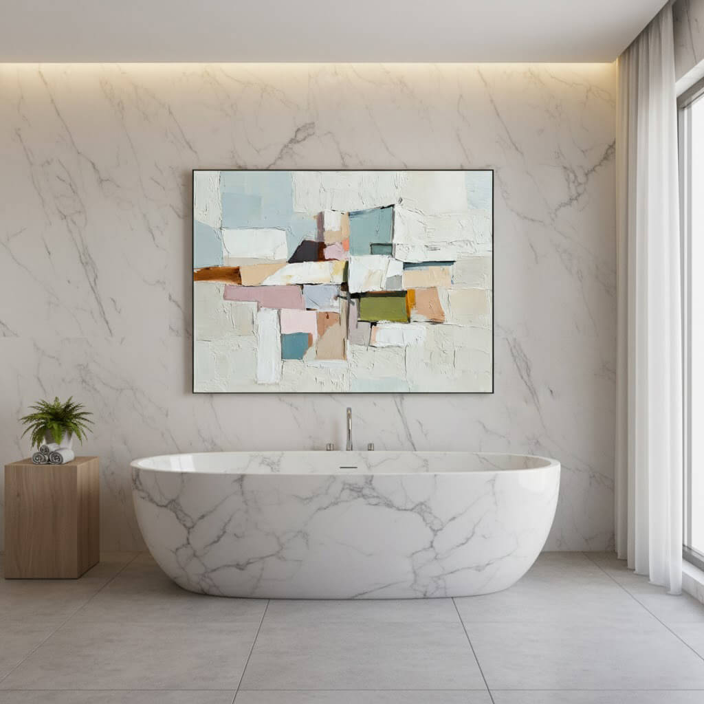 Modern bathroom with a marble bathtub and abstract art on the wall.