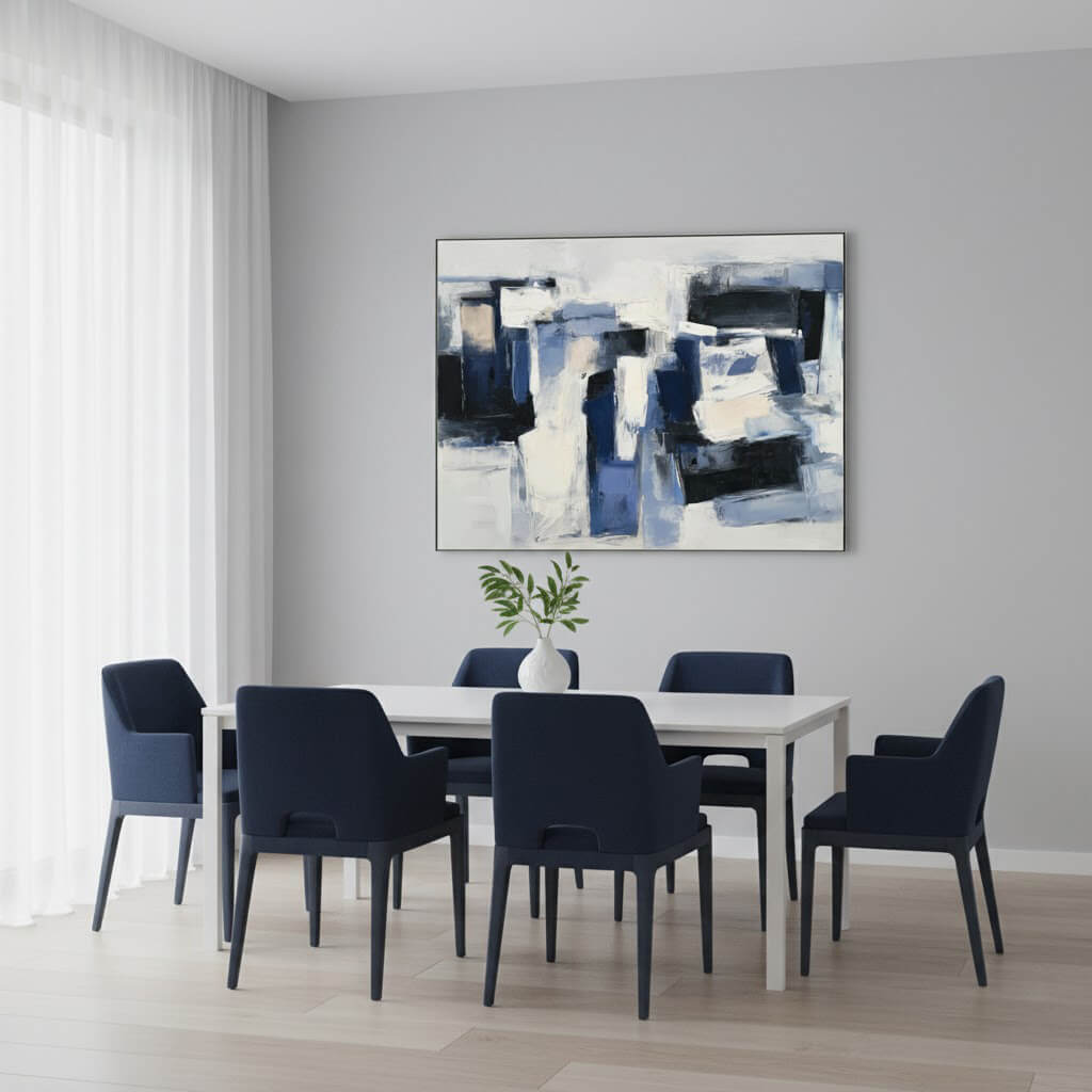 Dining room with a white table and blue chairs, abstract painting on the wall.