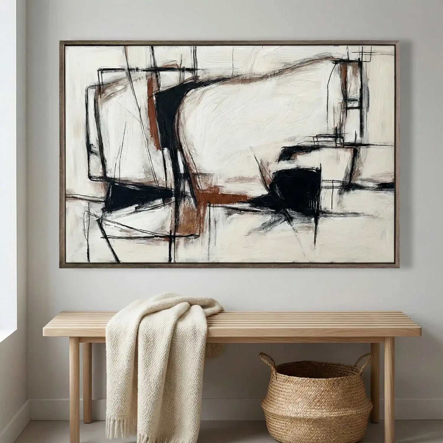 Abstract painting on a wall above a wooden bench with a blanket and basket.
