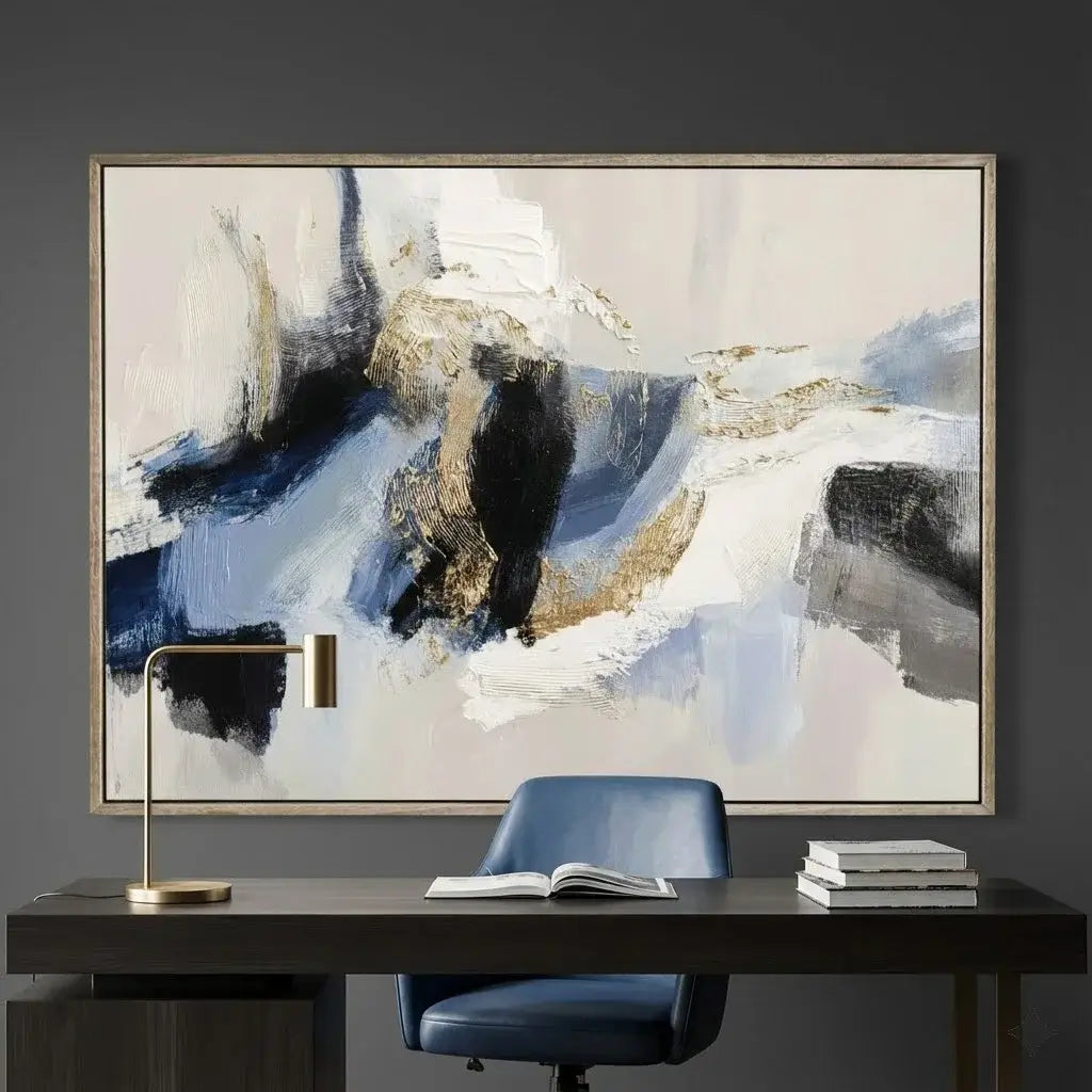 Abstract painting on a wall above a desk with a chair and lamp.