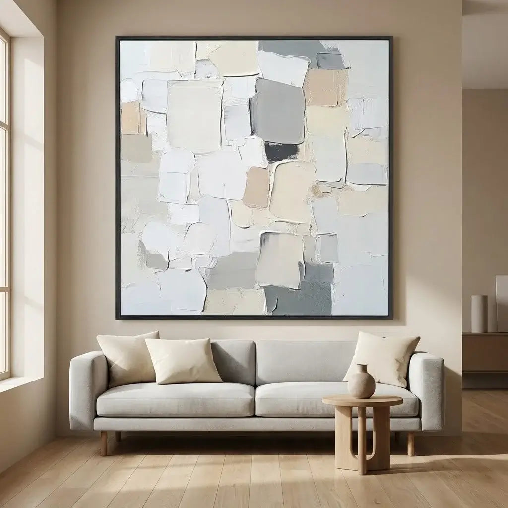 Living room with a gray sofa, small table, and abstract art on the wall.