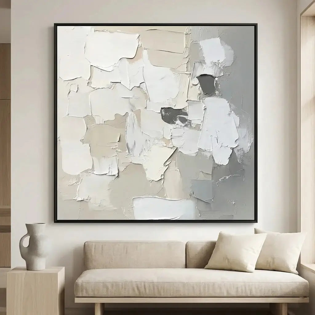 Abstract art piece in a modern living room setting with a sofa and decorative vase.