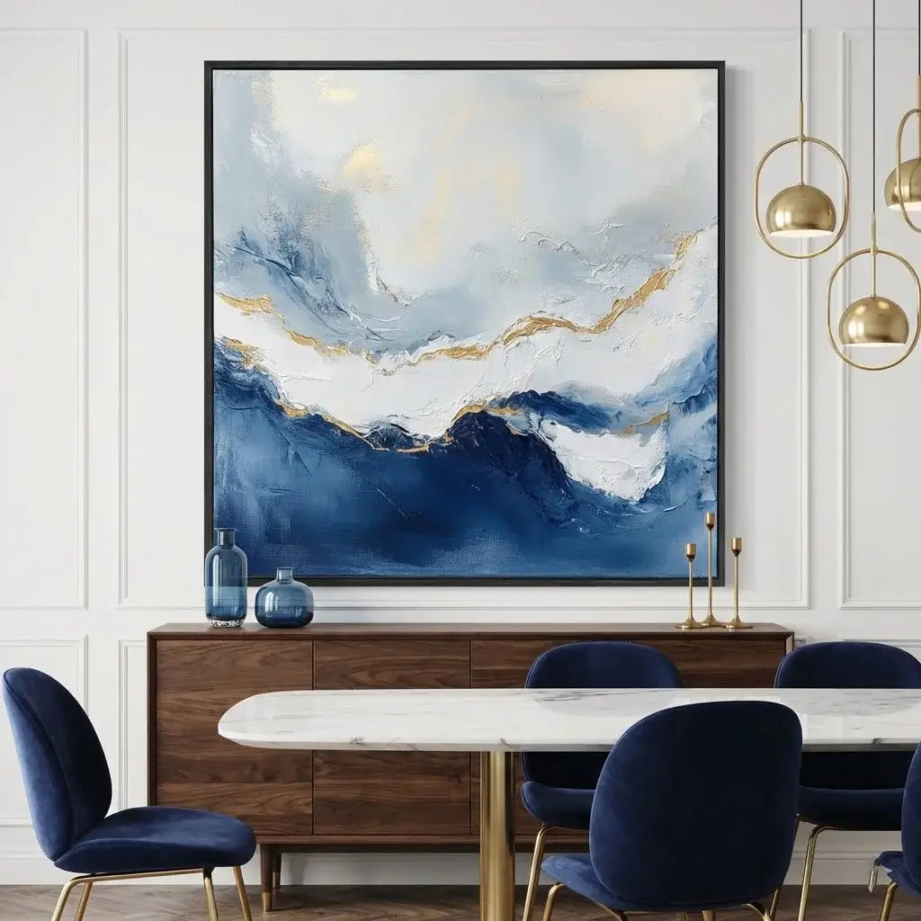 Dining room with abstract painting, marble table, and blue chairs.