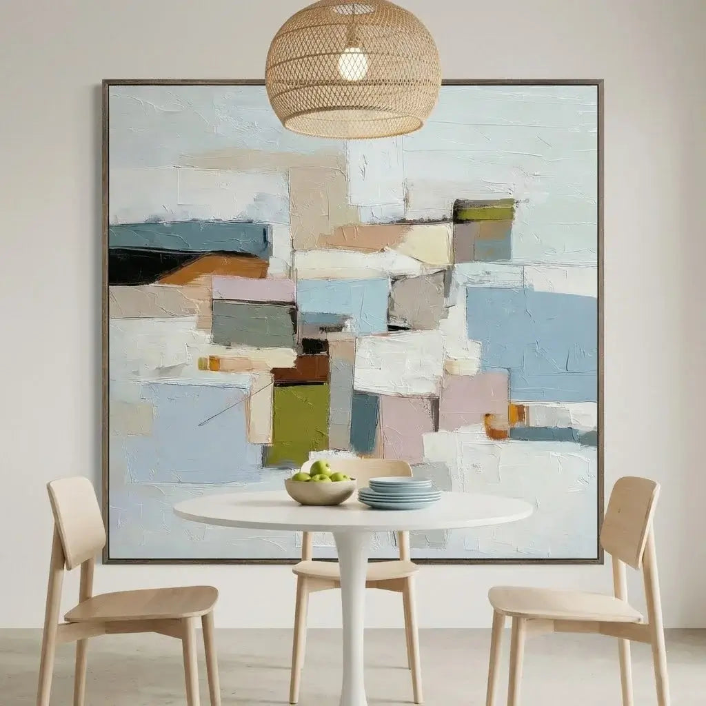 Dining room with abstract art on the wall, round table, and chairs.