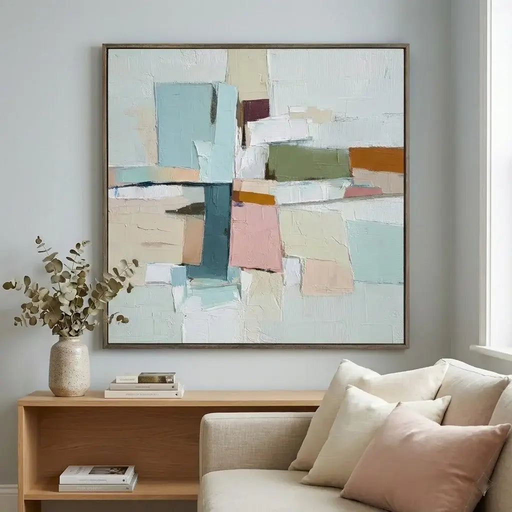 Abstract art piece on a wall above a sofa in a living room