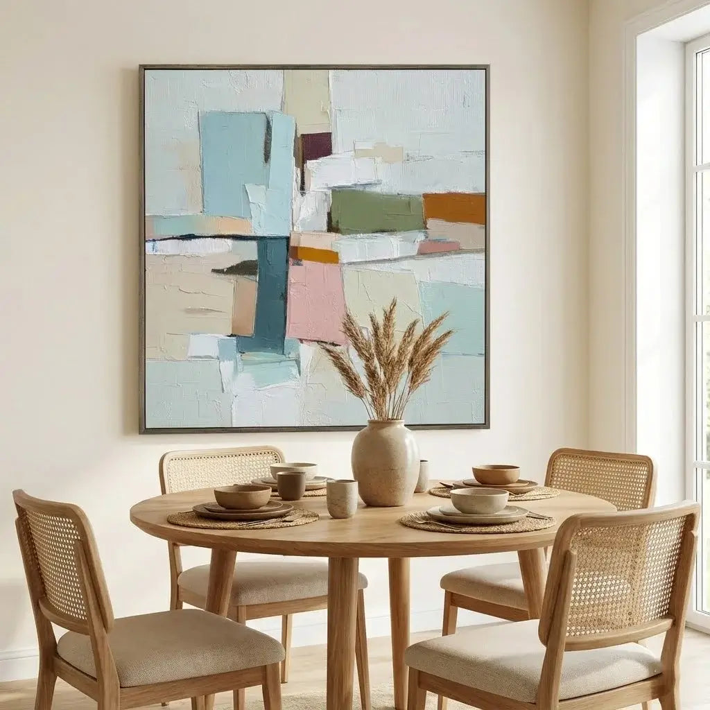 Dining room with a round wooden table and chairs, featuring a colorful abstract painting on the wall.