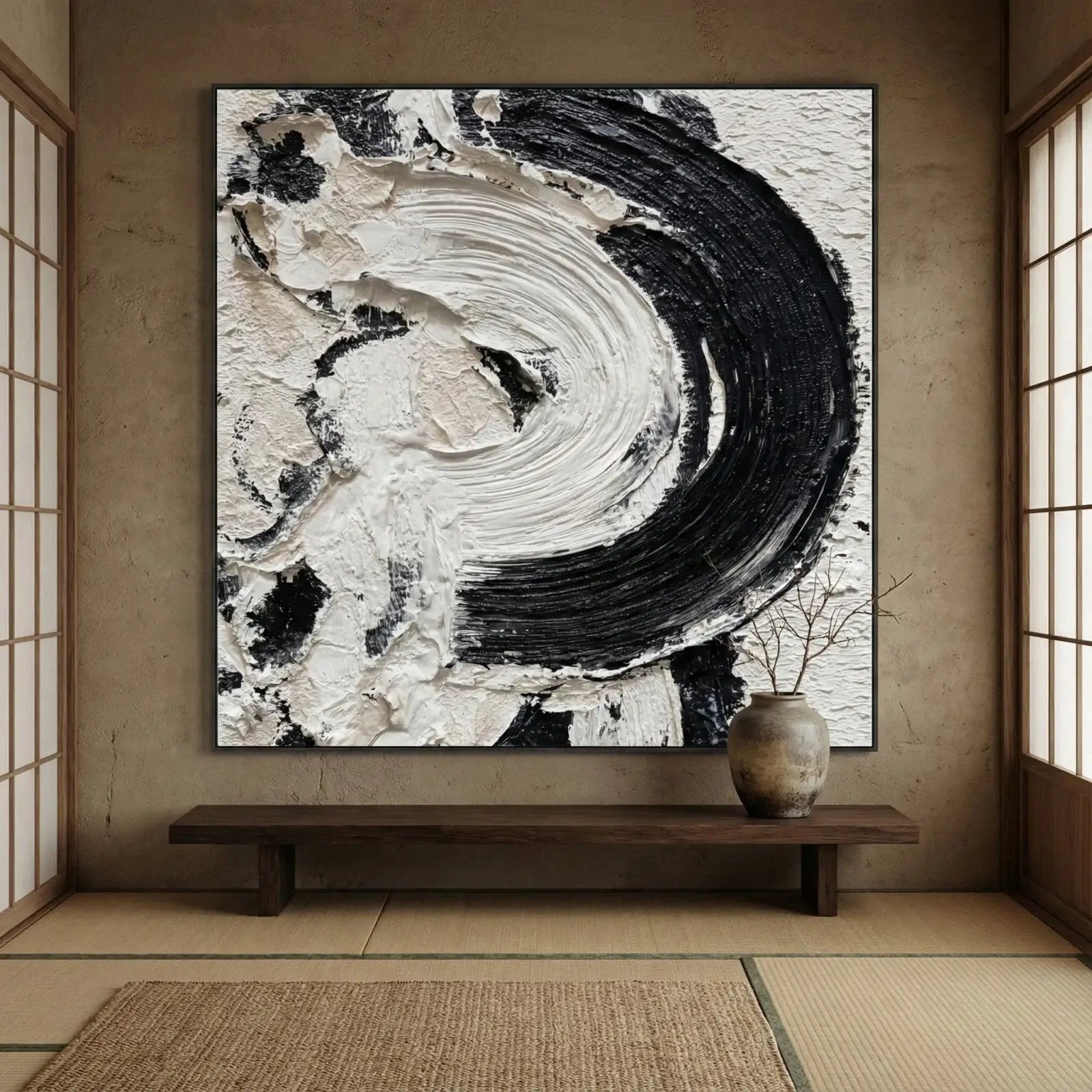 Abstract black and white painting in a room with wooden floor and sliding doors.
