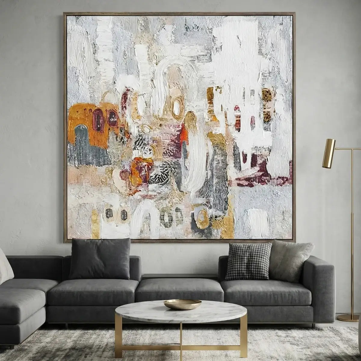 Abstract painting above a gray sofa in a living room