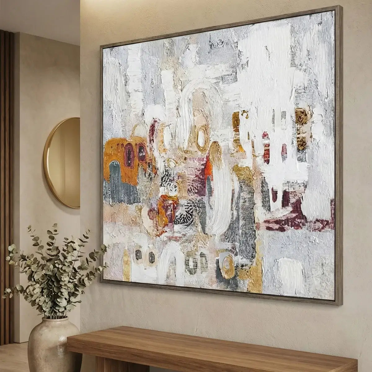 Abstract painting on a wall above a wooden console table with a vase of flowers.
