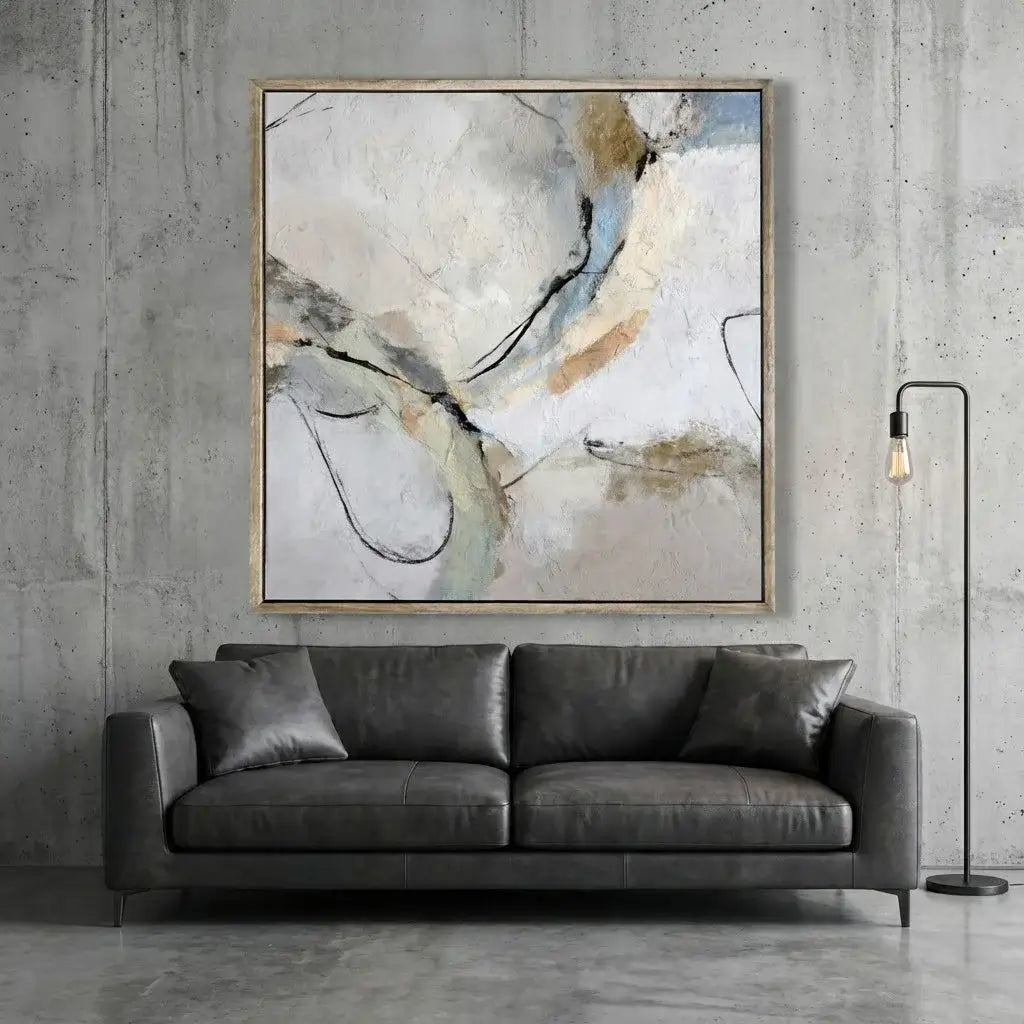 Gray sofa in a room with a large abstract painting on the wall.