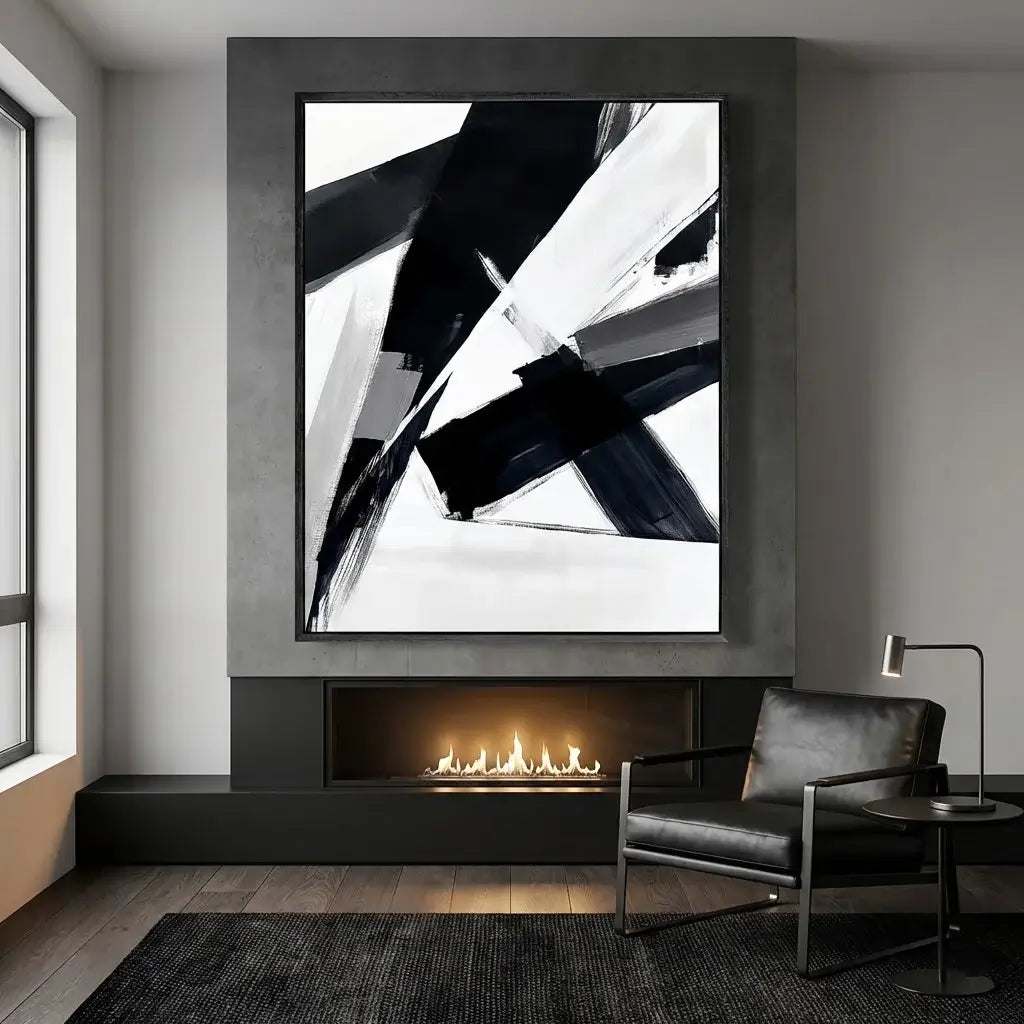 Modern living room with abstract black and white artwork above a fireplace.