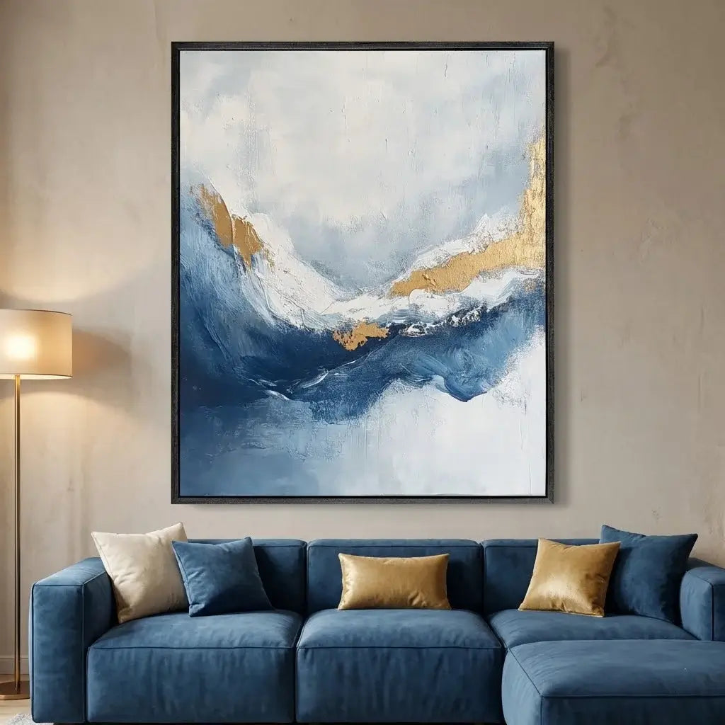 Blue sofa with gold and white abstract painting on wall