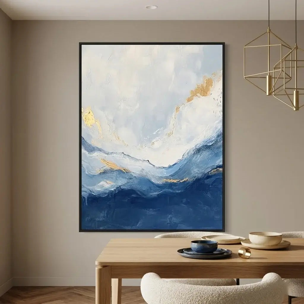 Abstract painting with blue and gold tones on a wall above a console table and bench.