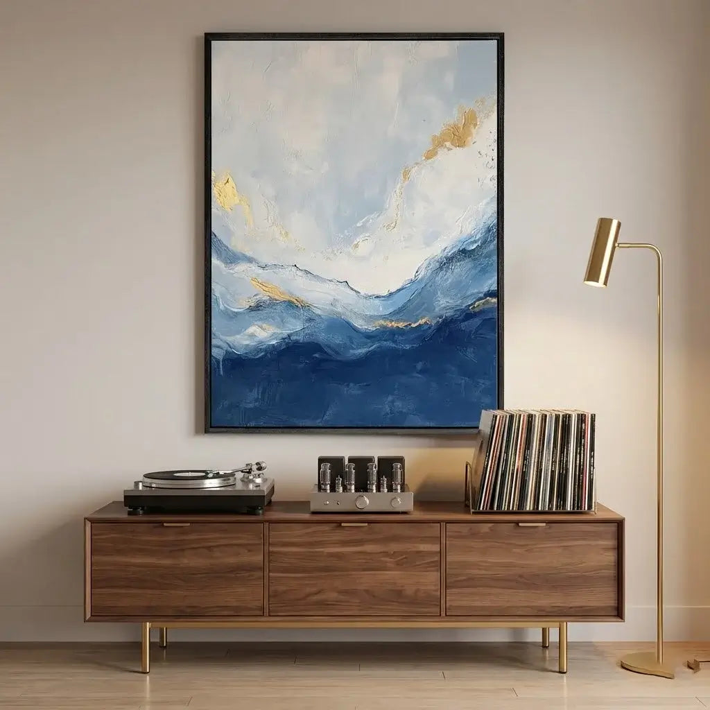 Wooden entertainment console with turntable, speakers, and vinyl records, featuring a large abstract painting above.