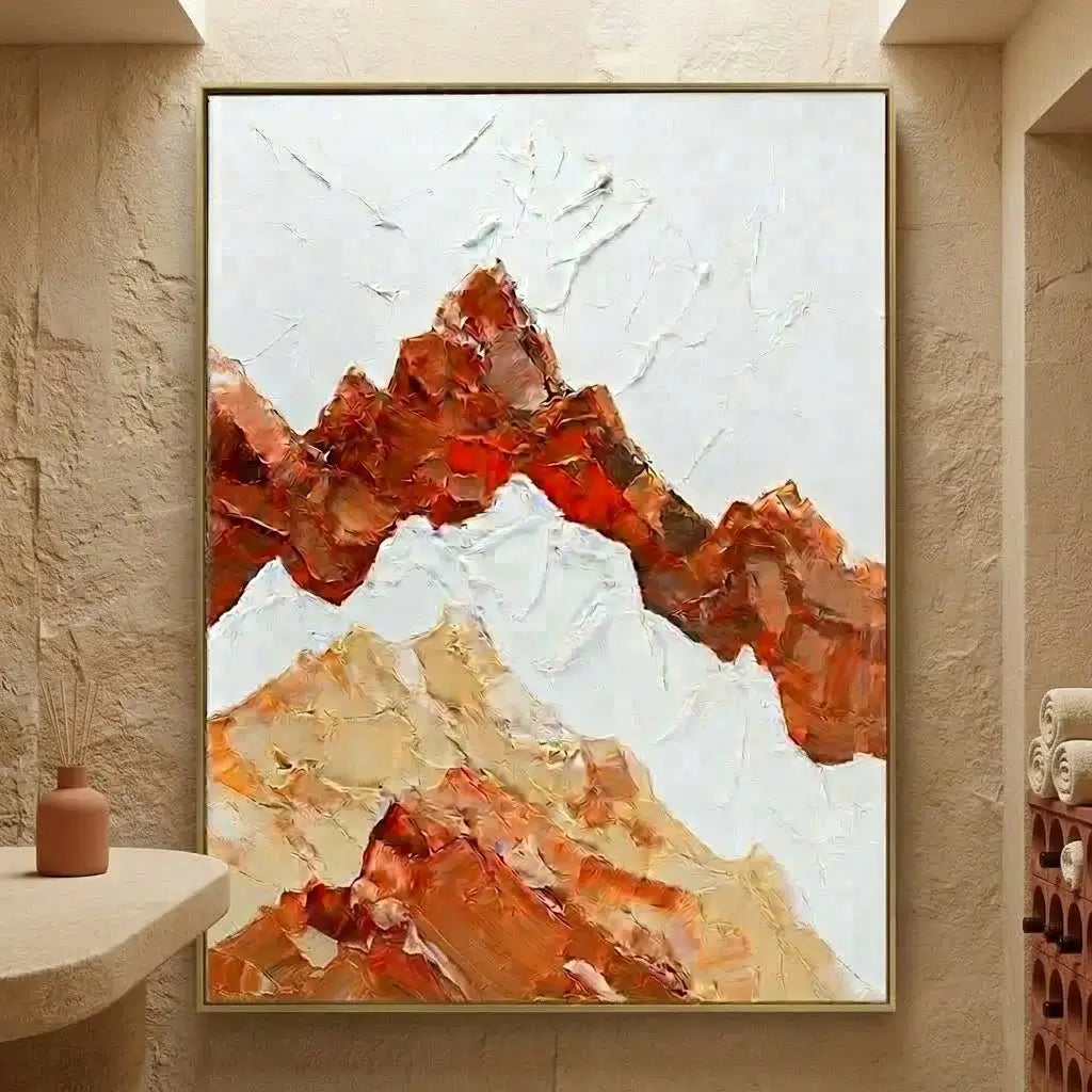 Living room with a large abstract mountain painting, beige sofa, and potted plants.