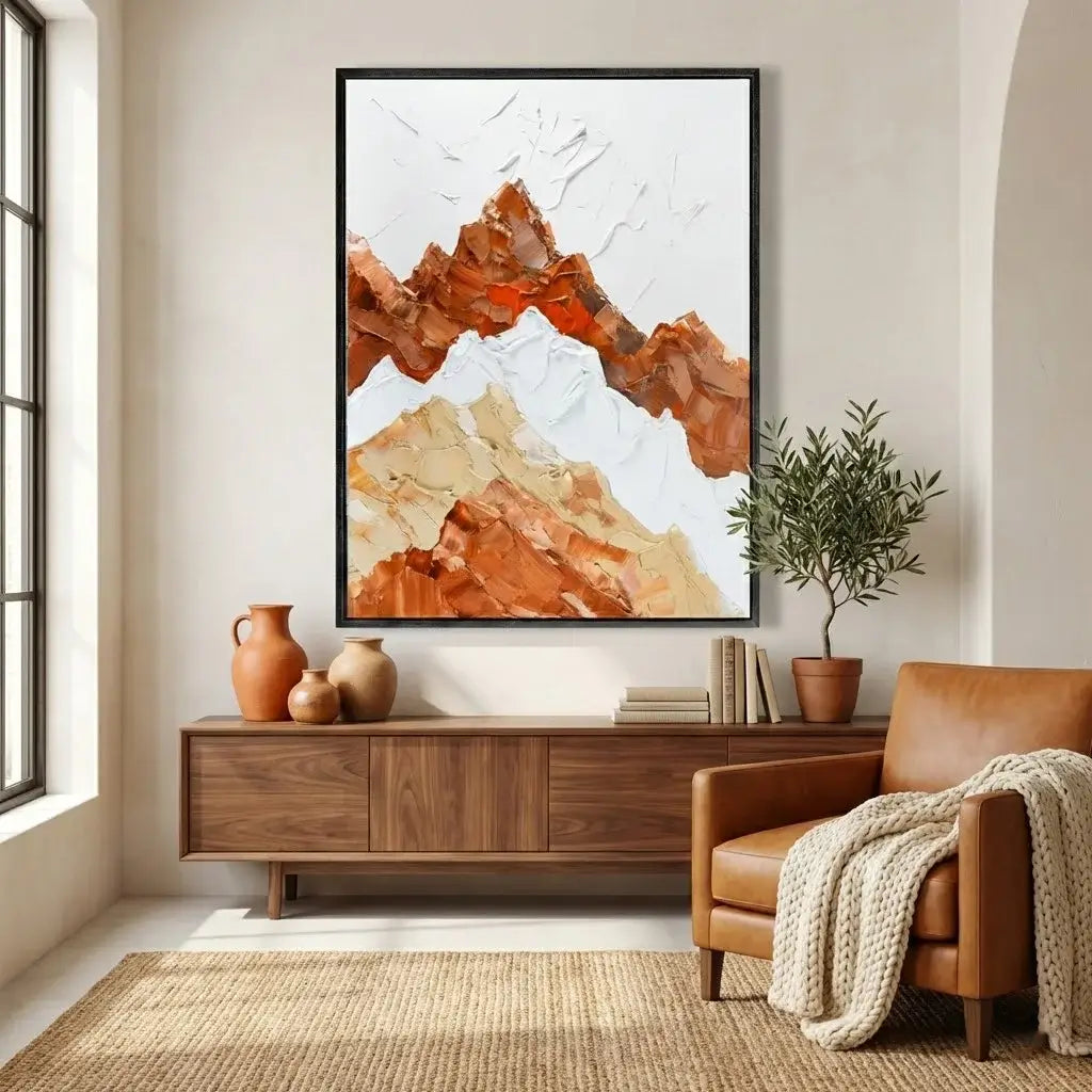 Living room with a large abstract mountain painting, wooden sideboard, and brown armchair.