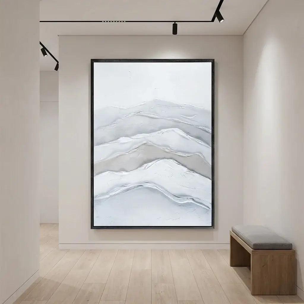 Framed abstract wall art in a modern interior setting with a bench.