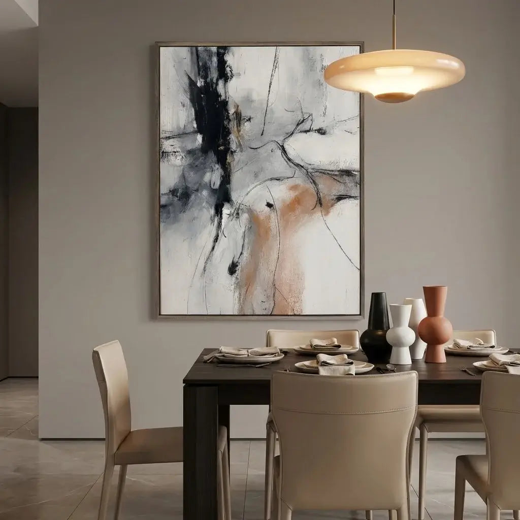 Dining room with a table set for four, abstract painting on the wall, and modern pendant light.