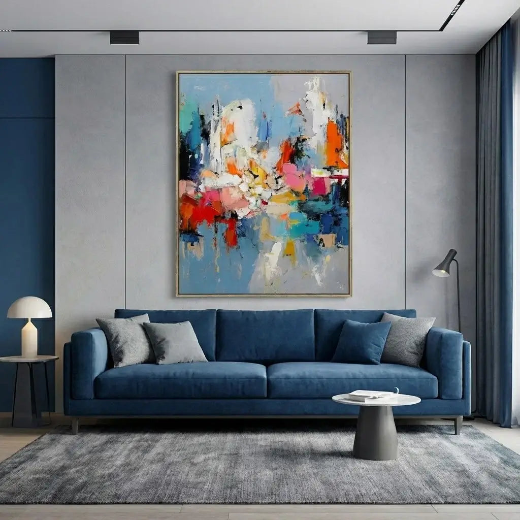 Modern living room with a blue sofa, abstract painting, and side table.