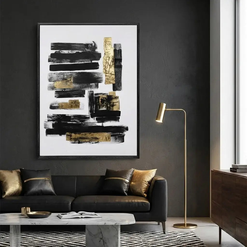 Modern living room with abstract art, black sofa, and gold accents