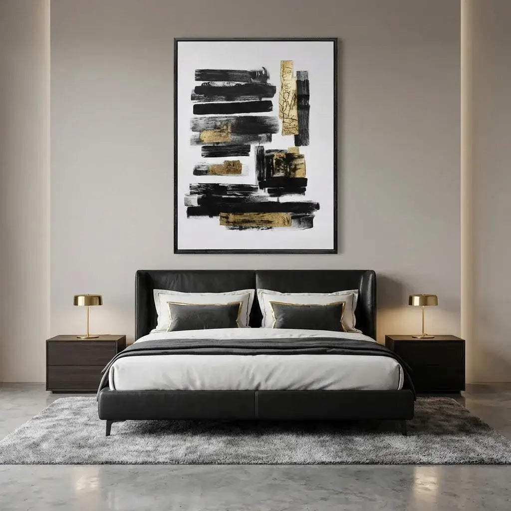Modern bedroom with a black bed, abstract art on the wall, and two lamps.