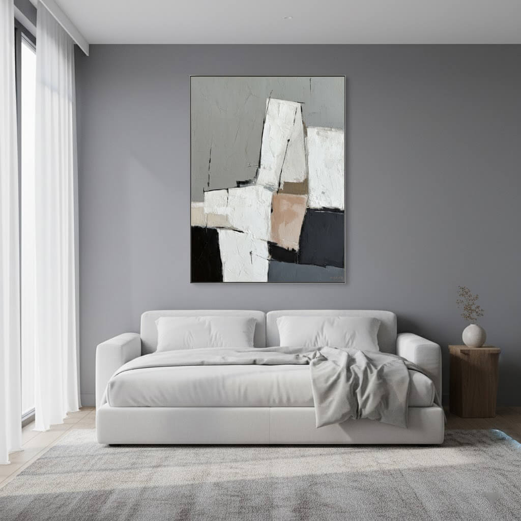 Modern living room with a gray sofa and abstract painting on a gray wall.
