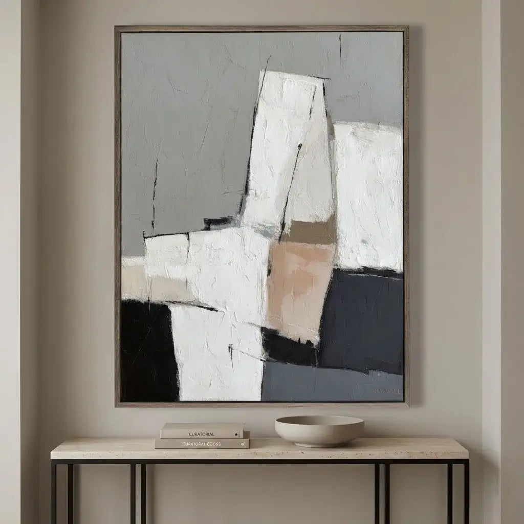 Abstract art piece on a wall above a console table with decor items.