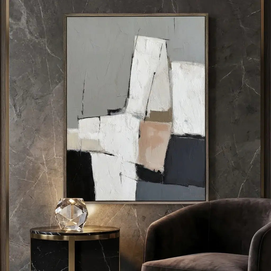 Abstract art piece on a wall with a modern chair and side table.