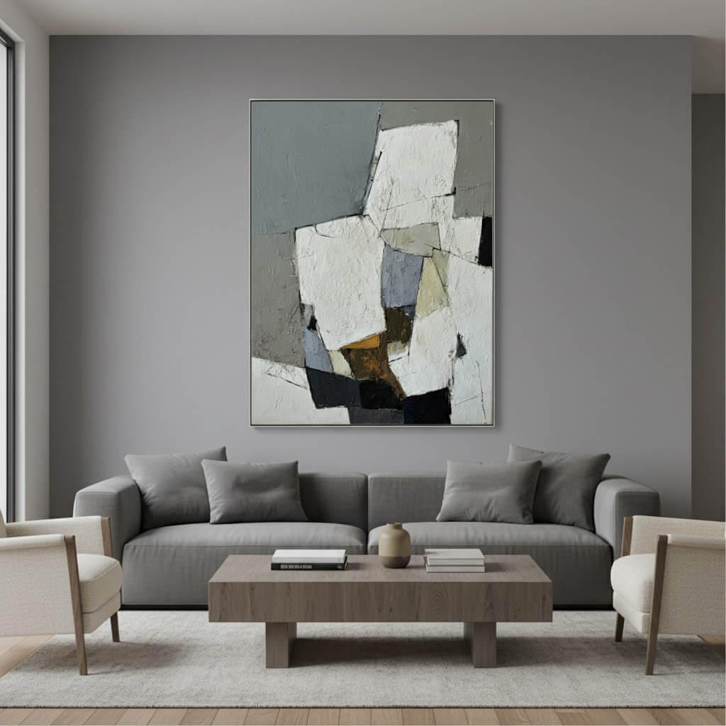 Modern living room with a gray sofa, abstract painting, and wooden coffee table.