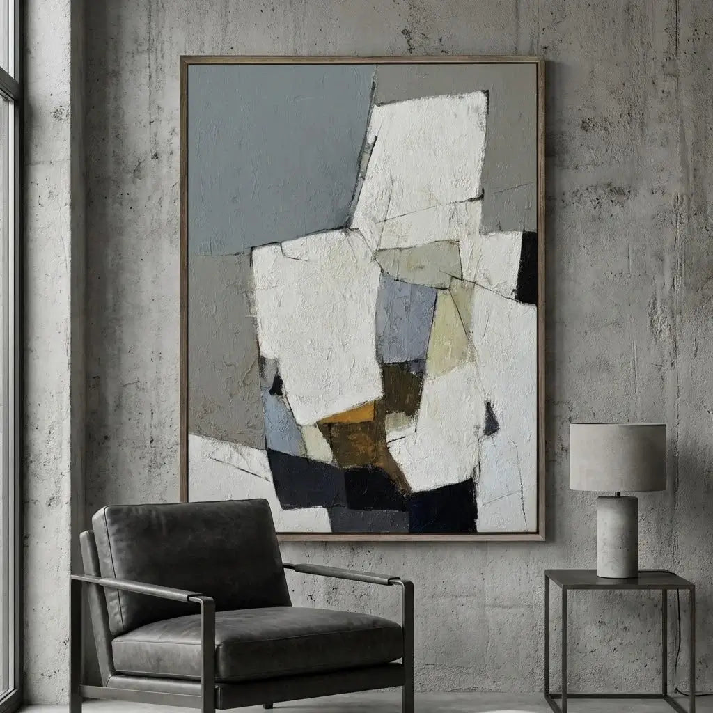 Abstract art piece on a wall with a chair and lamp in a room.