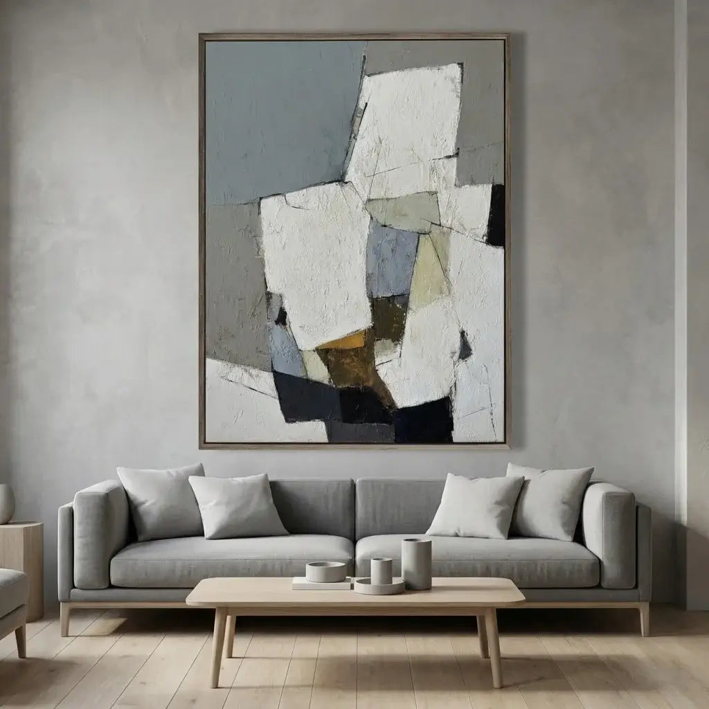 Gray sofa with a wooden coffee table and abstract art on the wall in a living room.