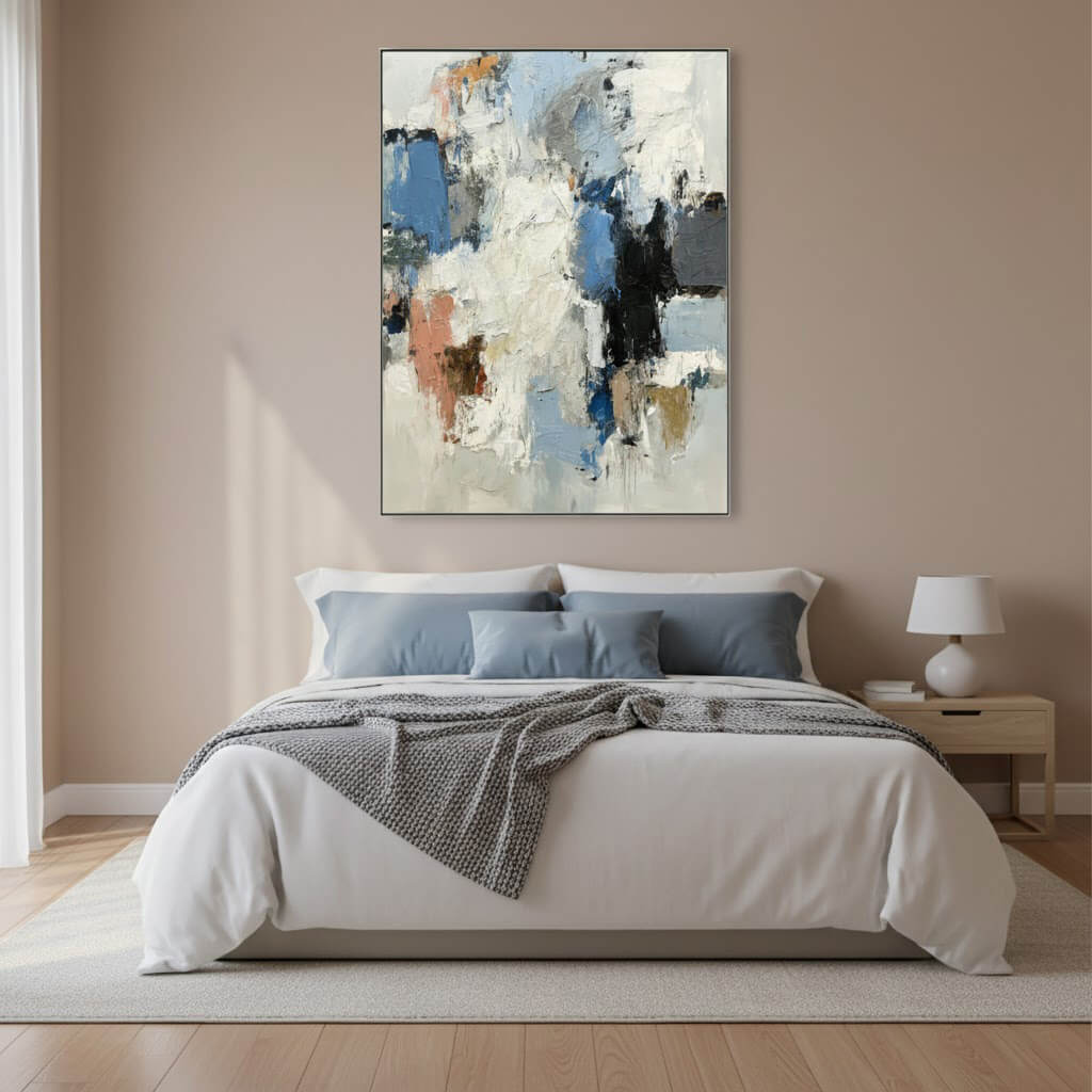 Abstract painting above a bed in a bedroom with neutral colors