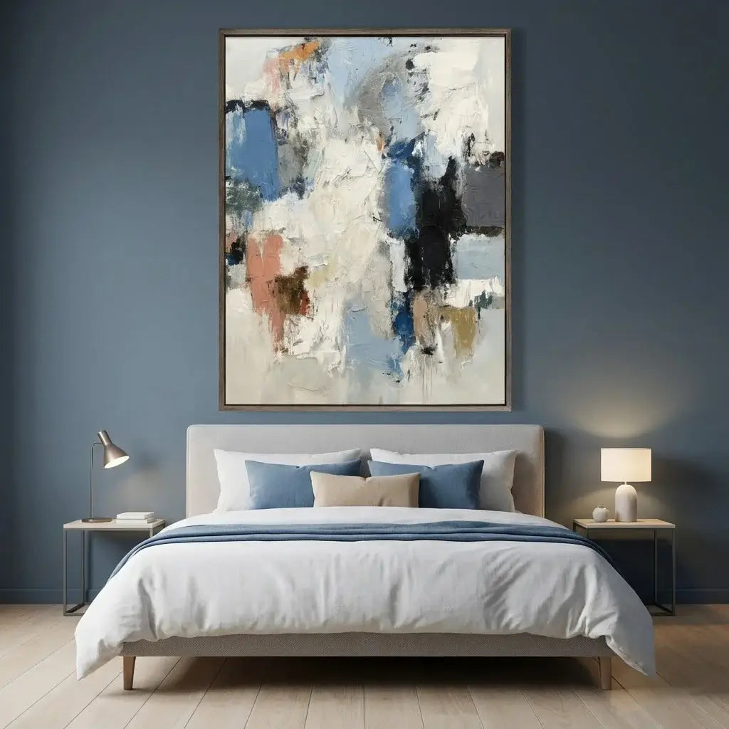 Modern bedroom with abstract art on the wall, bed with pillows, and side tables with lamps.