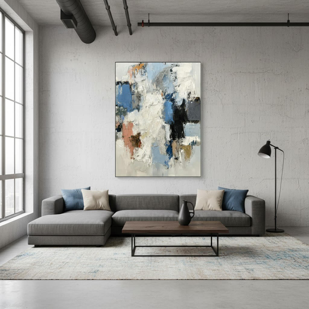 Modern living room with a gray sectional sofa, abstract painting, and wooden coffee table.