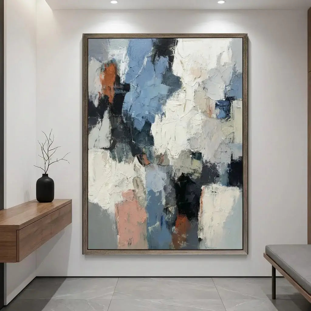 Abstract painting in a modern interior setting with a wooden console table and bench.
