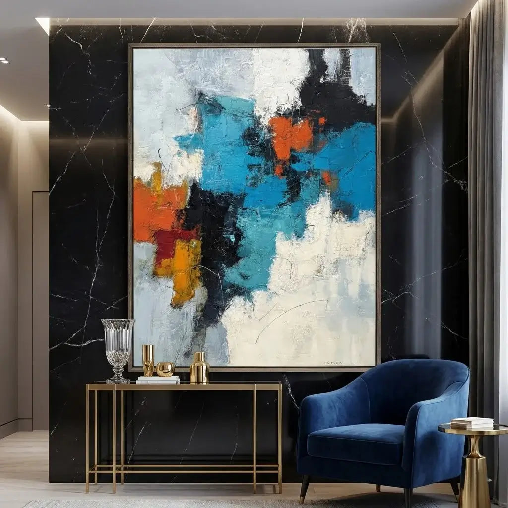 Modern interior with abstract art, console table, and blue armchair.