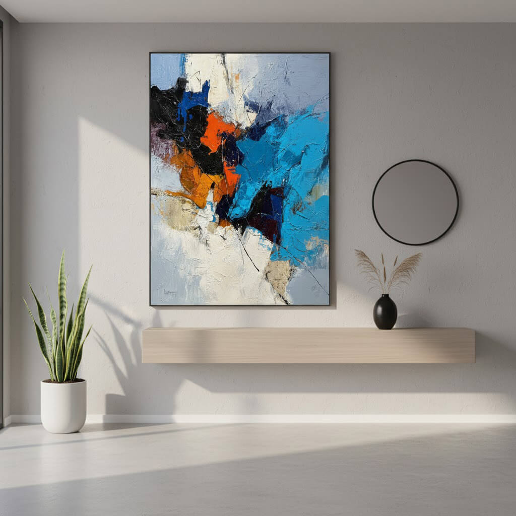 Abstract painting on a wall with a plant and shelf below