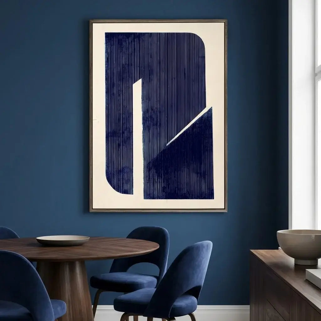 Abstract art piece on a blue wall in a room with a dining table and chairs.