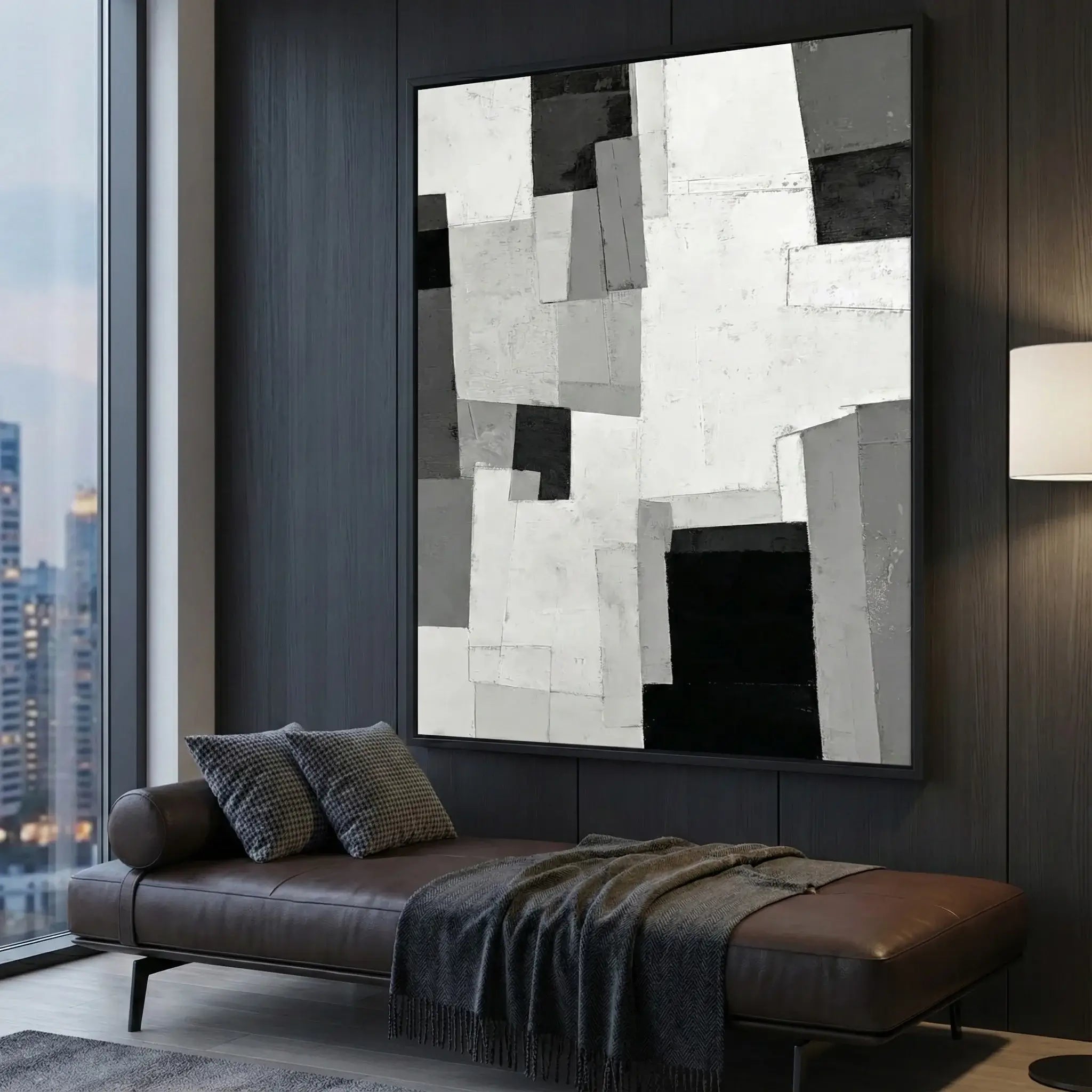 Modern living room with abstract art on the wall, sofa, and large window.