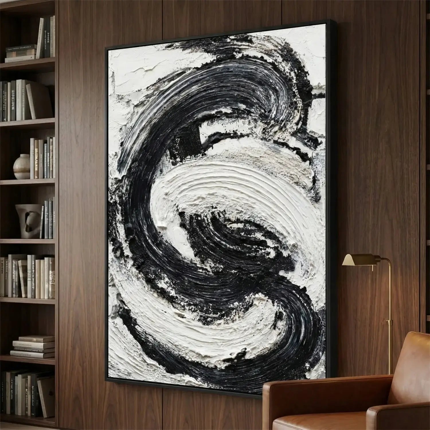 Abstract black and white painting in a modern interior setting with a bookshelf and chair.