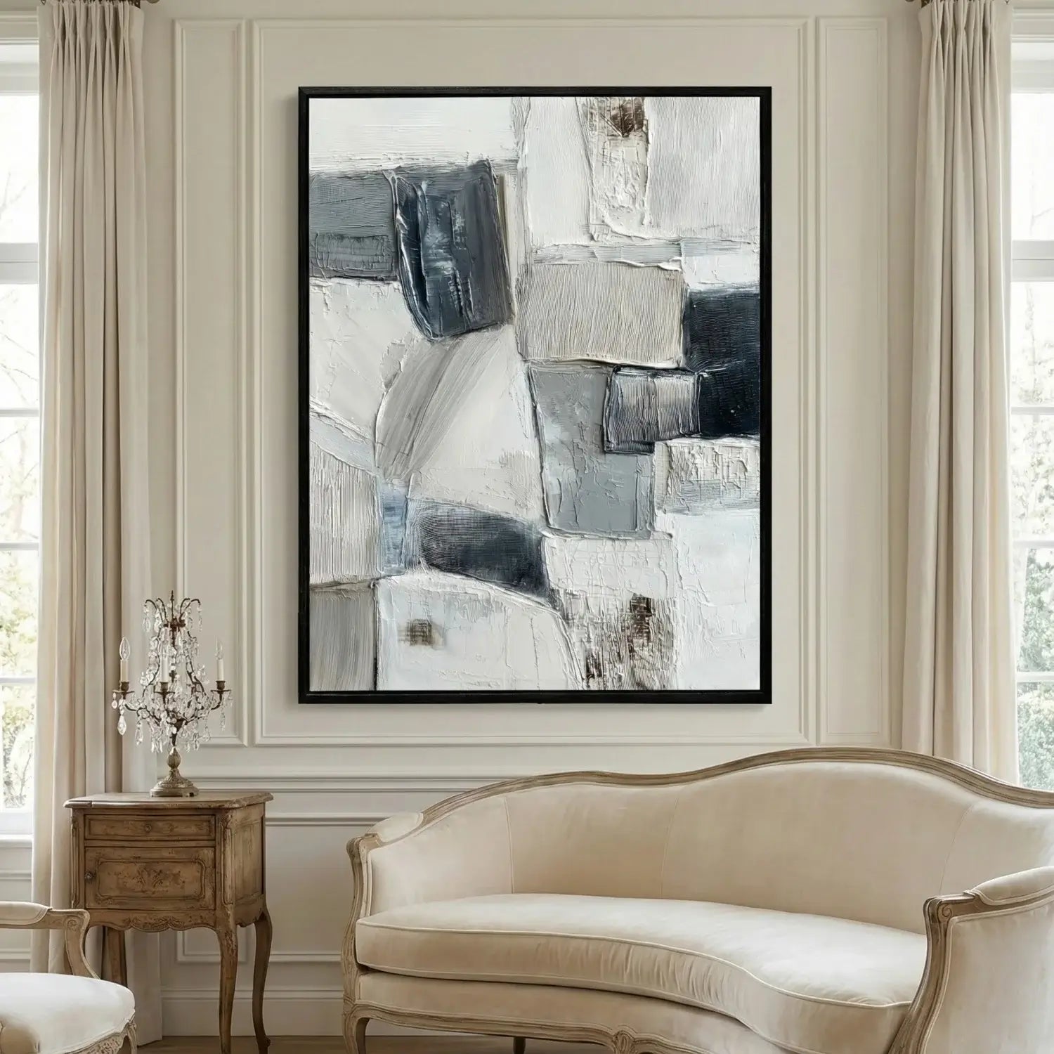 Abstract art piece on a wall in a room with a sofa and side table.