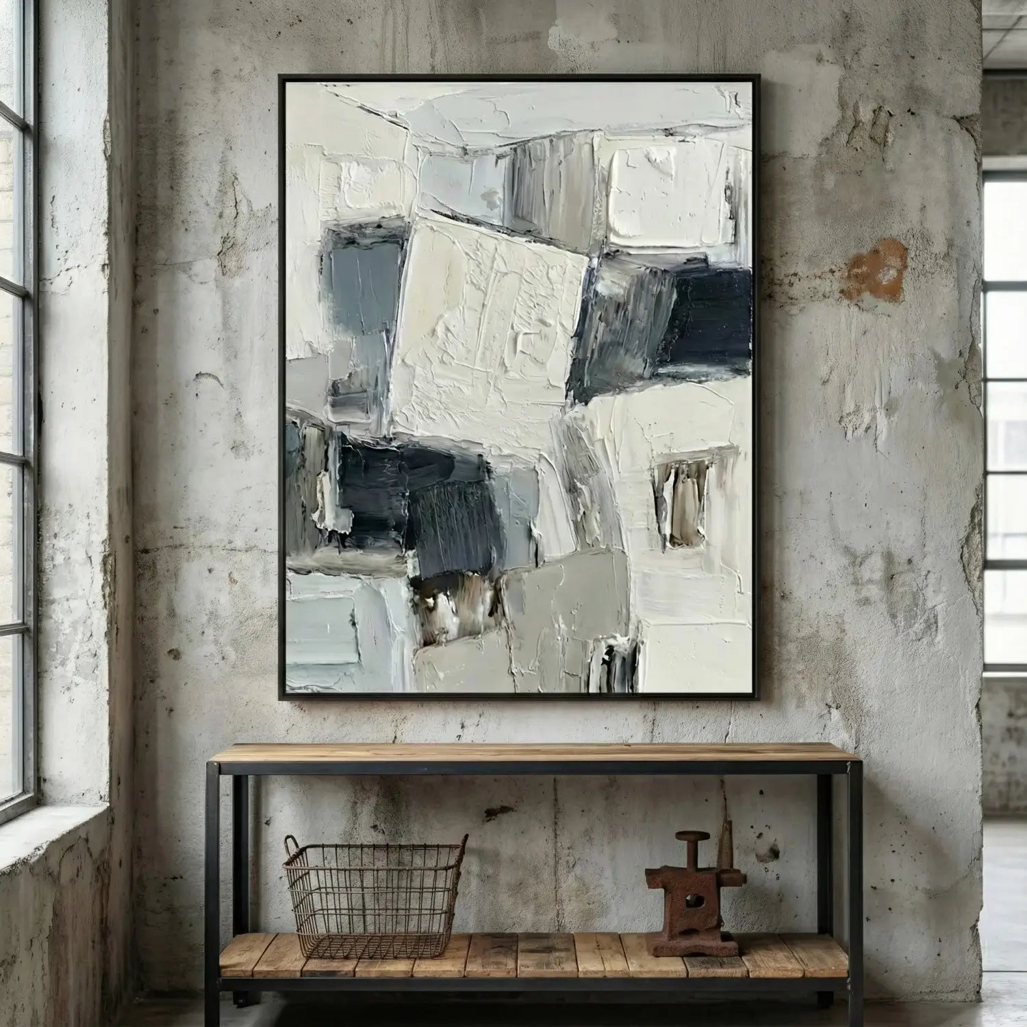 Abstract painting on a textured wall above a wooden console table.