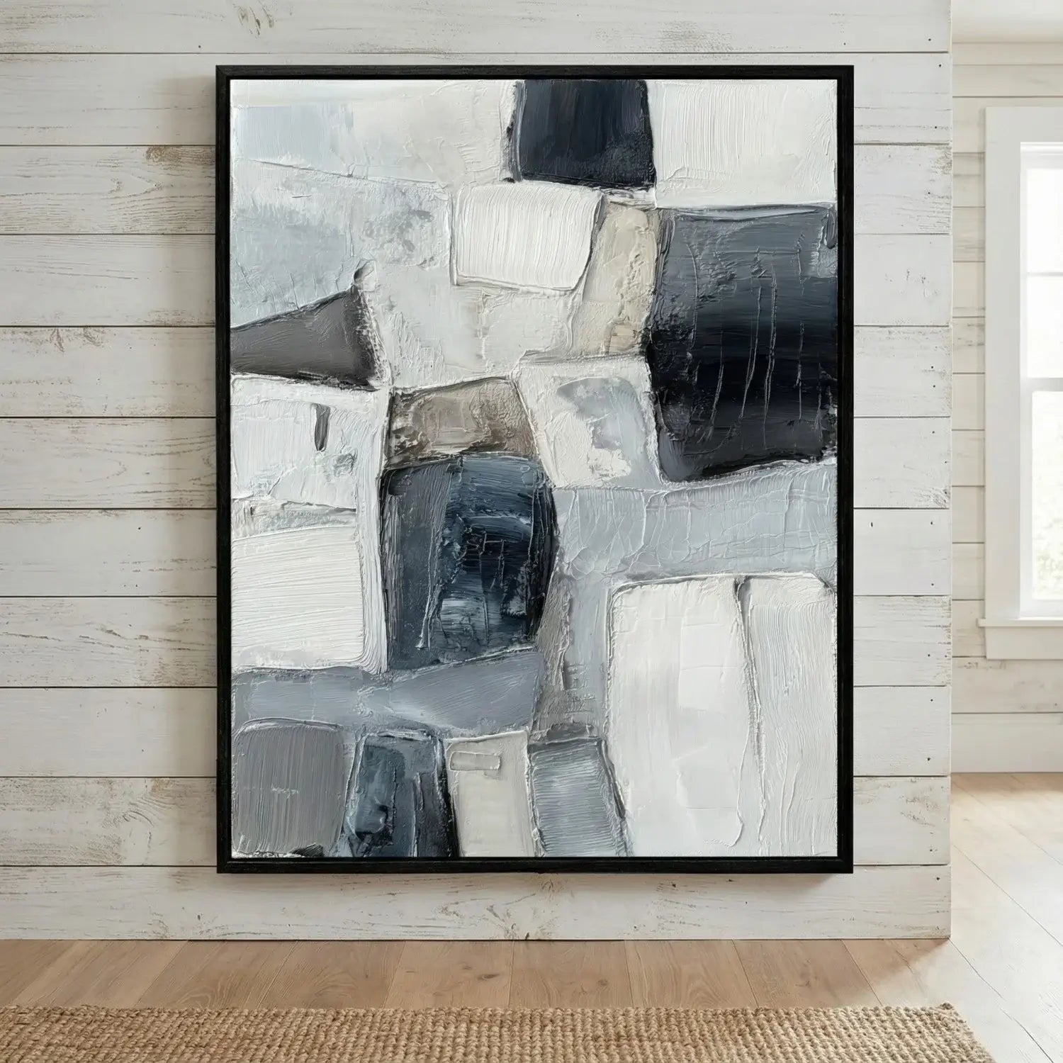 Abstract art print in a black frame on a wooden wall.